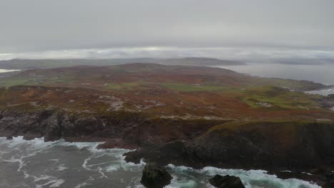 aerial parallax of malin head from the sea, with dramatic fog for an epic shot.