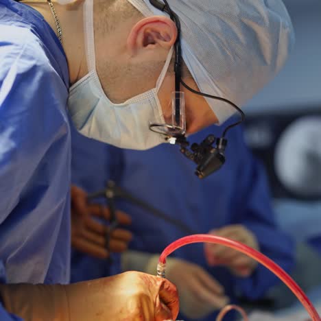 operation by professional surgeon. medical specialist together with female assistant perform a surgery using sterile surgical instruments. close-up