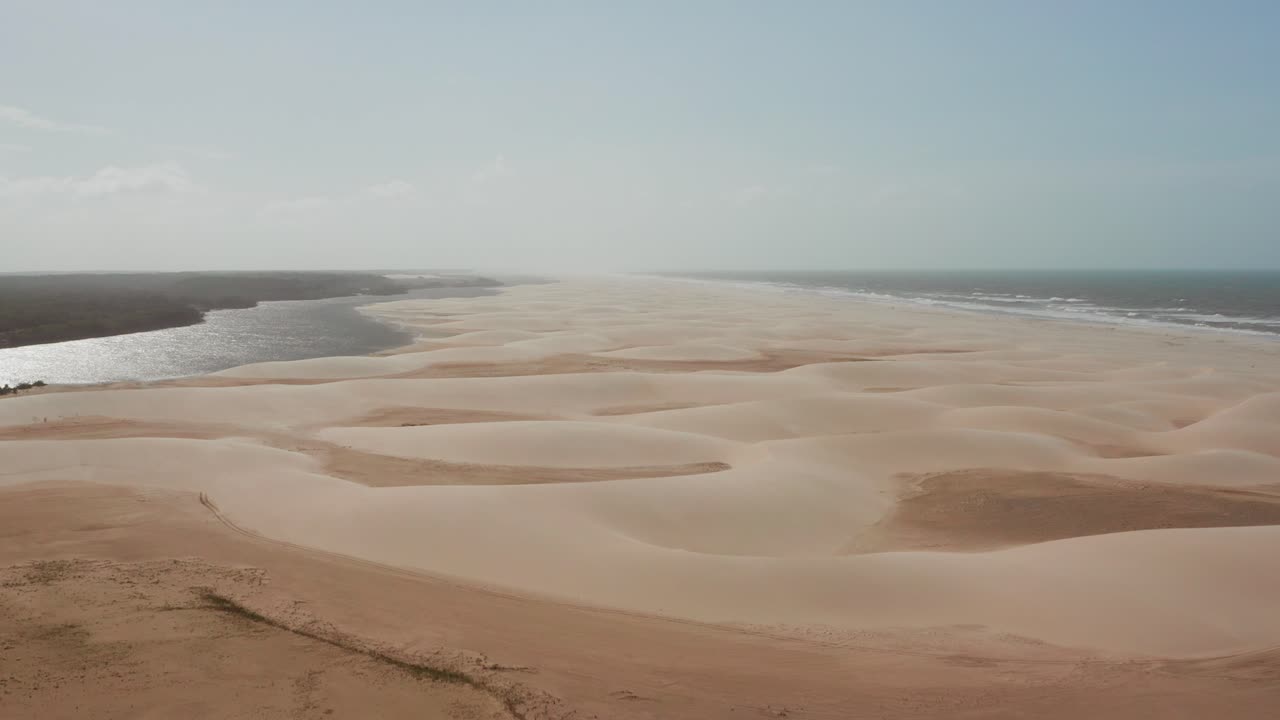 Aerial view of a beach with sand dunes and a river