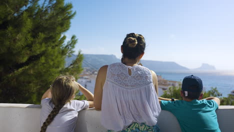 family enjoying a view from a balcony