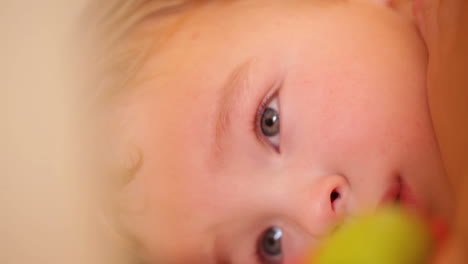 little boy watching a film in the playpen