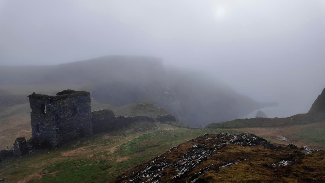 Ireland on the edge of the Atlantic 3 Castles Head West Cork Ireland moody ruins of a haunted castle in a remote headland on a winter misty day