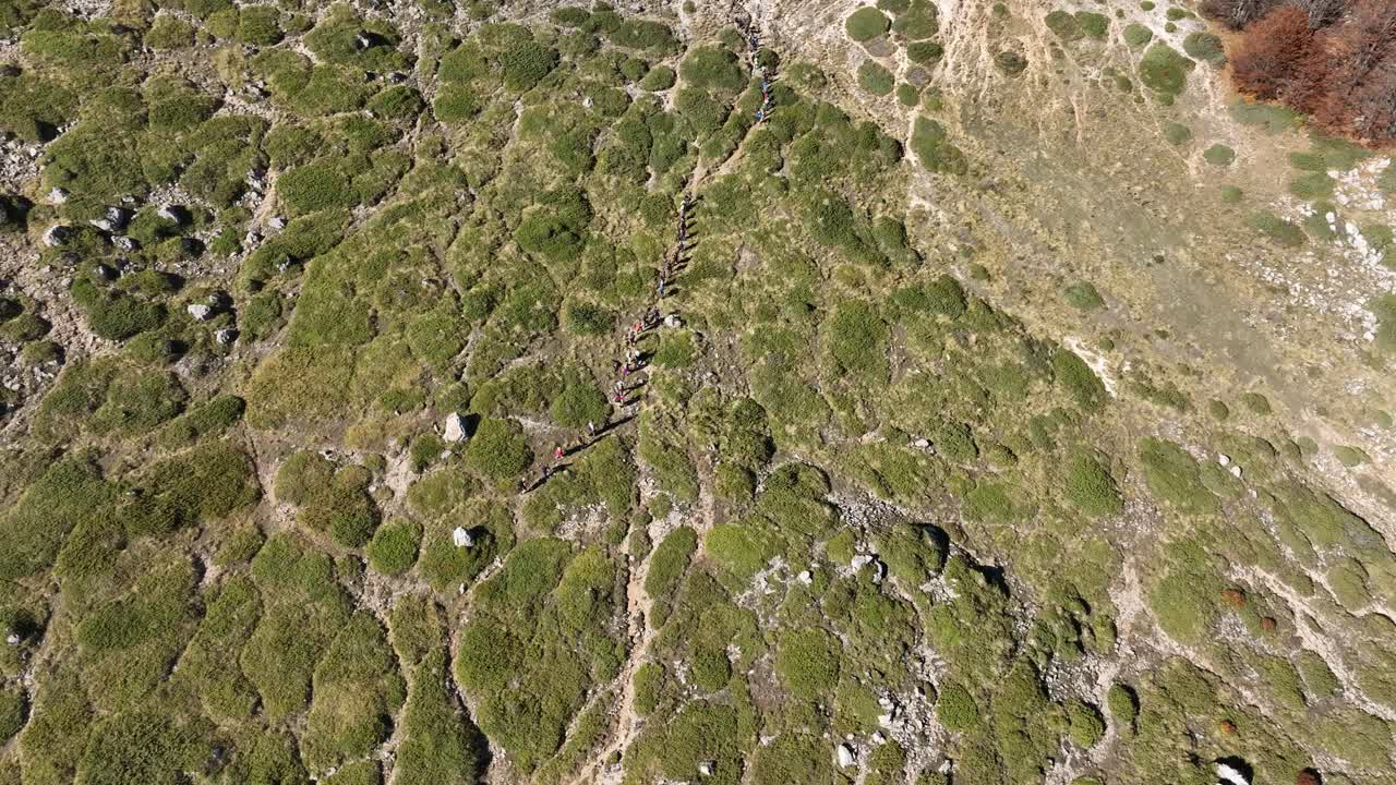 Exhilarating mountain trip in north Greece, herd of people trekking on harsh slope - Mount Vermio 4k aerial