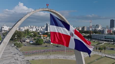 close up shot of waving flag of dominican republic in front of skyline in santo domingo