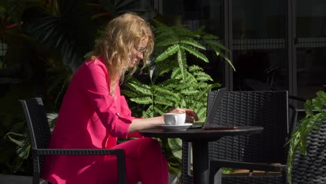 Young-female-sits-outside-during-sunny-day