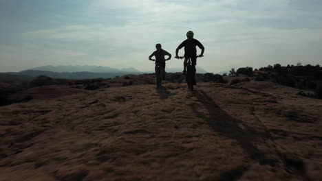 two unrecognizable athletic men mountain biking