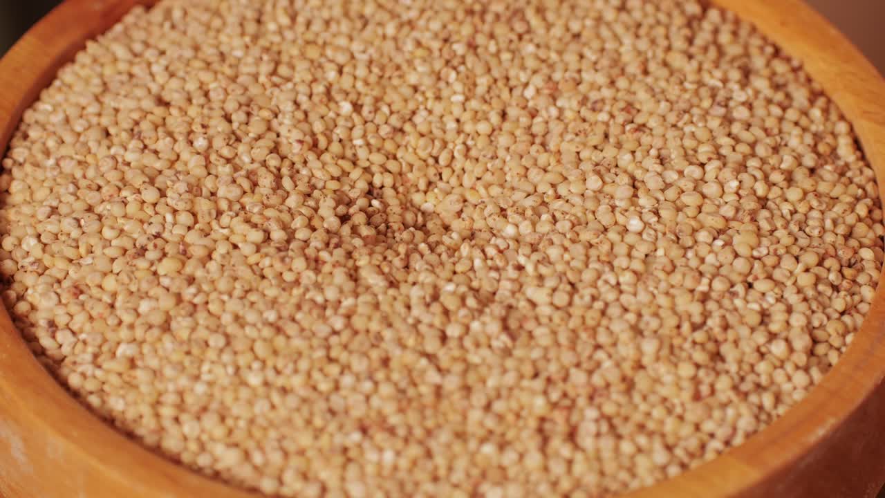 Close-up shot of treatment of seeds of cereals: rye, barley, wheat against diseases and insects using modern equipment. Hard wheat in hopper being ground into whole wheat flour. High quality 4k footage