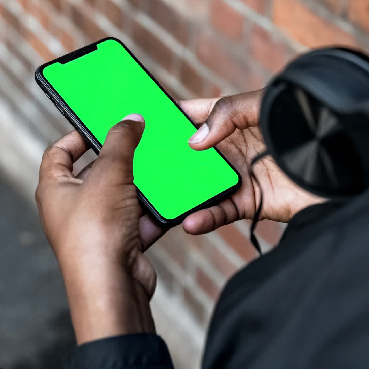 Mobile phone screen in hands of a man live mockup animation, transparent 4K video, green screen