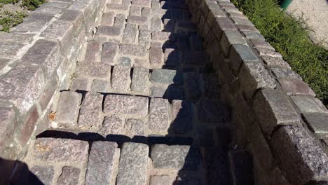 person walking down at the cobblestone stairway on