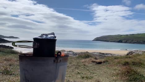 timelapse of cooking food in camping pots over open fire