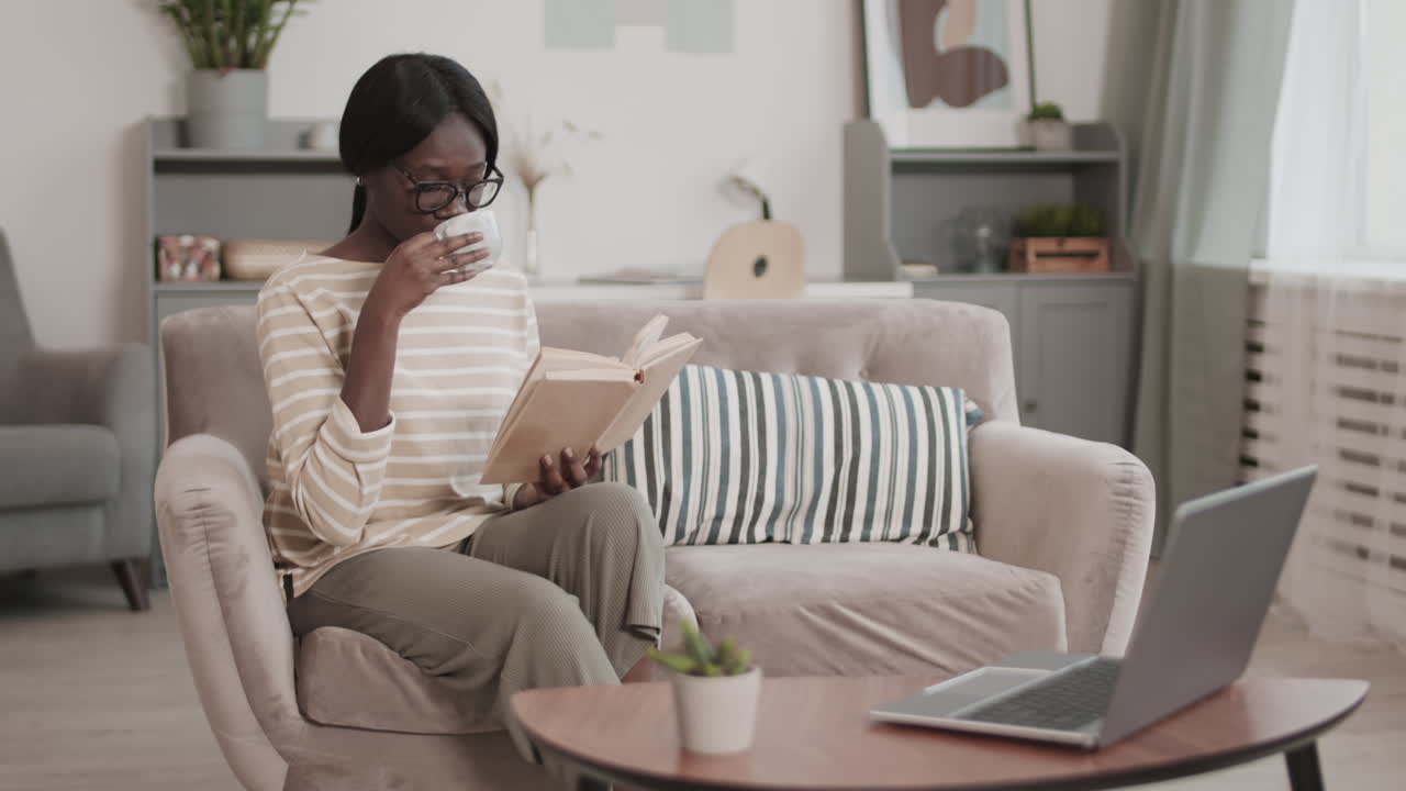 African Woman Reading Book at Home