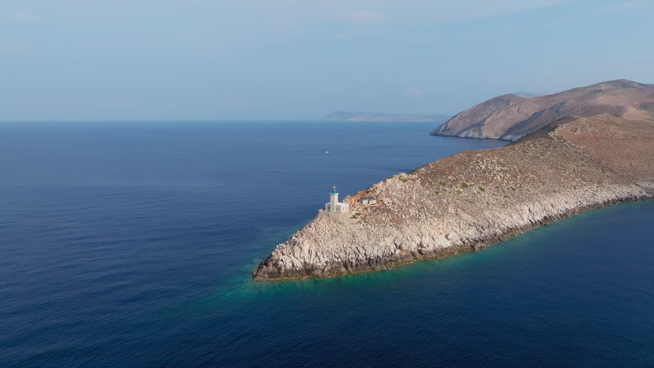 Aerial of rocky Cape Tainaron stretching into calm blue sea, southern Peloponnese coast establishing