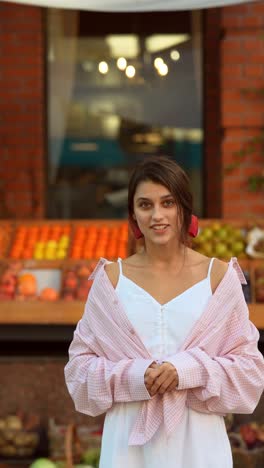 young woman in pink shirt at the market
