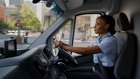 a woman driving a delivery van through a city