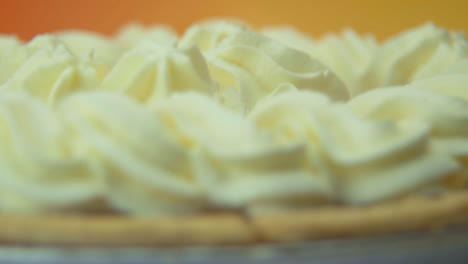 [camera used: canon c300] macro shot soft focus rotating pumpkin pie loaded with fluffy whipped cream