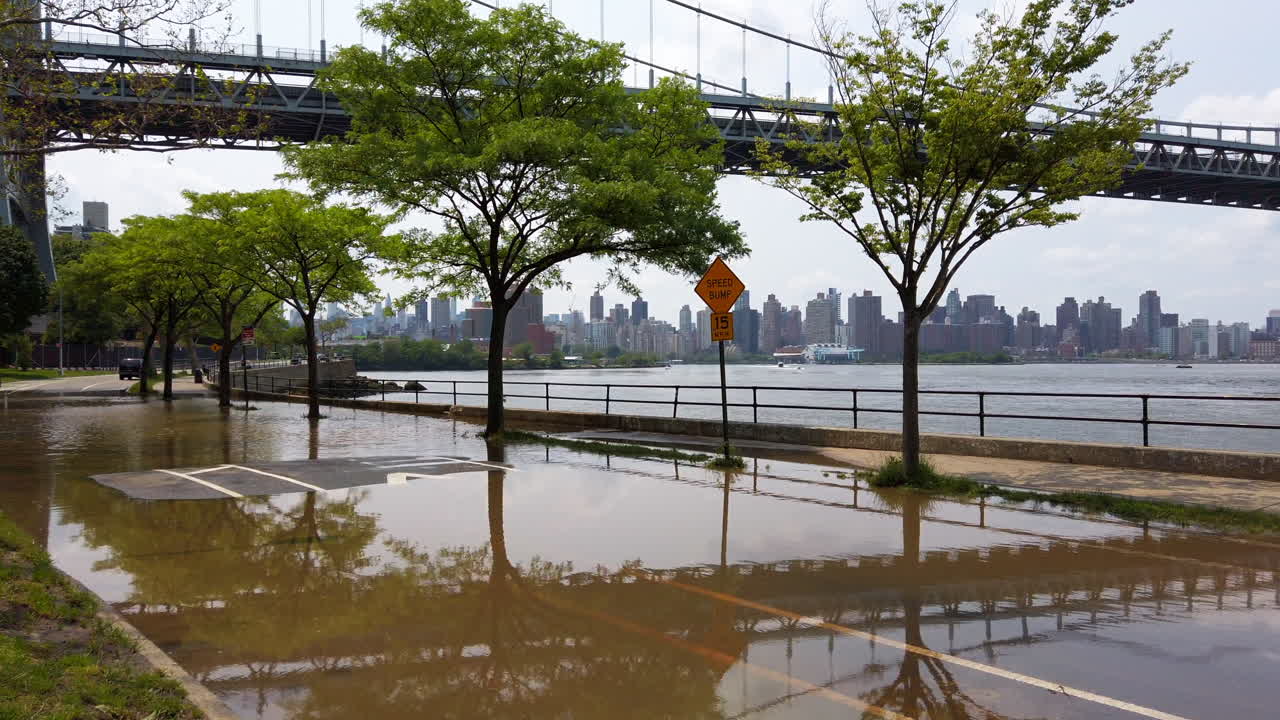 Flooded area of Astoria Park with Triboro Bridge and Manhattan in background.