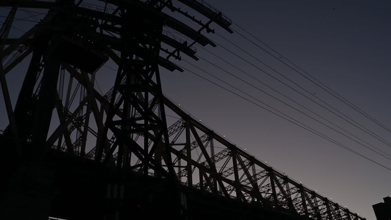 Night view of tramway car as it glides back to Manhattan in New York City, USA