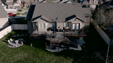 ascending aerial view of a home and backyard living space then reveal the lehi, utah location