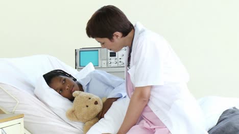 attentive nurse talking with a little boy