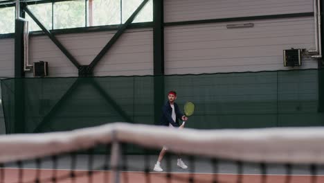 man playing indoor tennis