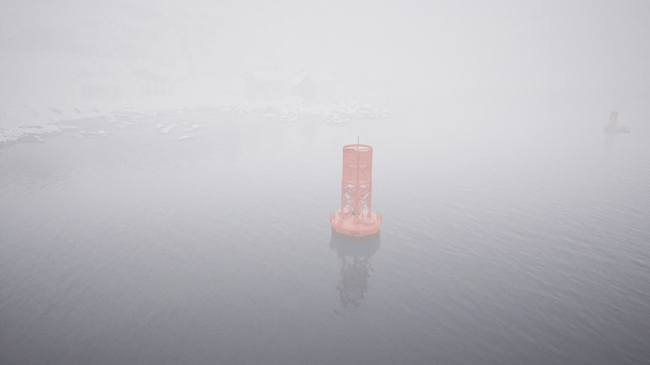 Foggy day with a solitary buoy standing in calm waters