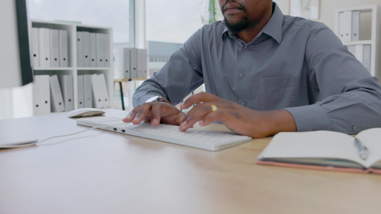Hands, black man and typing on computer in office