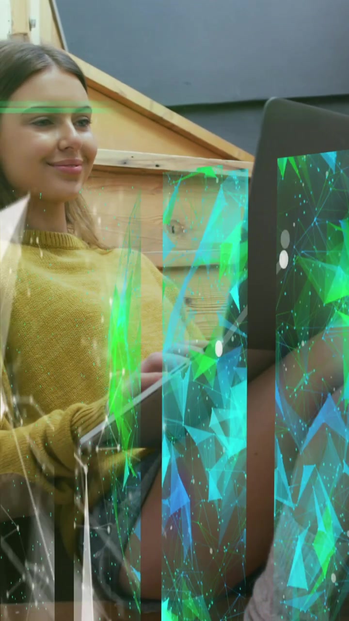 Animation of digital interface over business people using laptop