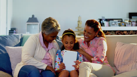 Happy-family-using-digital-tablet-in-living-room-4k