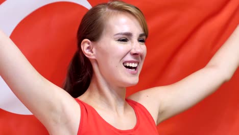 turkish young woman celebrates holding the flag of turkey in slow motion