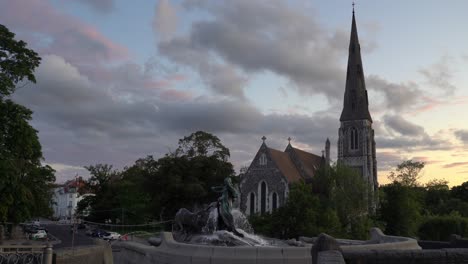 statue and fountain in front of a church in copenhagen, denmark