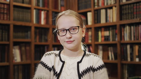 portrait of a student on the background of shelves with books in the library