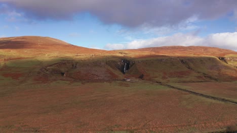 Aerial-Drone-flyover-a-waterfall-in-Fairy-Glen-in-Skye-Scotland-Autumn