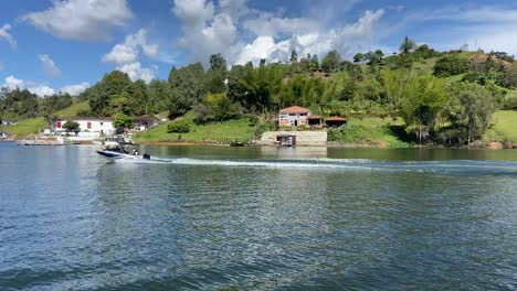 wealthy motorboat sailing guatape reservoir at sunny day