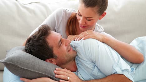 Cute-couple-lying-on-couch-chatting