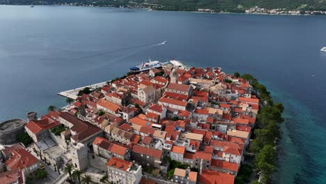 stunning aerial view of korčula's ancient town with red-tiled rooftops and ocean backdrop