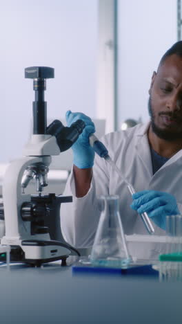 scientist using a microscope in a laboratory