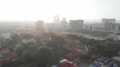 drone aerial footage in malacca old town, malaysia. top down aerial view of buildings, street, and market along a river in melaka, malaysia