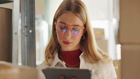 woman using tablet in warehouse