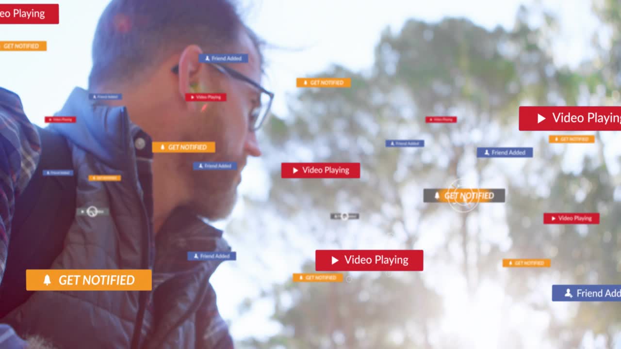 Vertical video: Man tapping phone in park causing play or notify icons spreading checking IT alerts