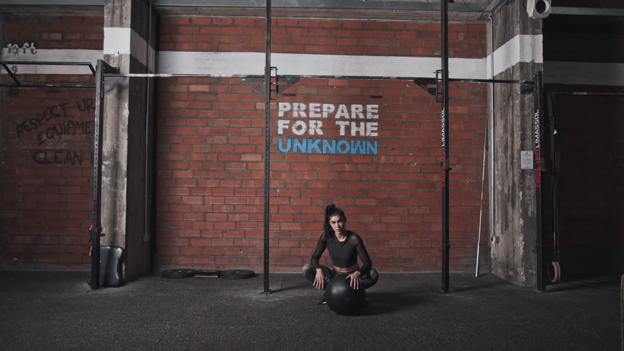 Confident Female Athlete Preparing for Workout in a CrossFit Gym