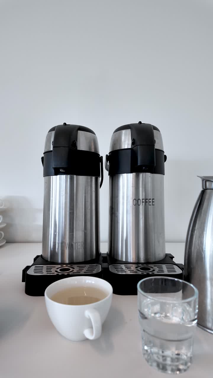 Catering per ufficio: termos dispenser di caffè e acqua calda per riunioni ed eventi. Video verticale.