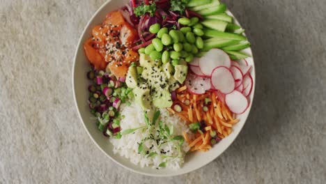 Composition-of-bowl-of-rice,-salmon-and-vegetables-on-white-background