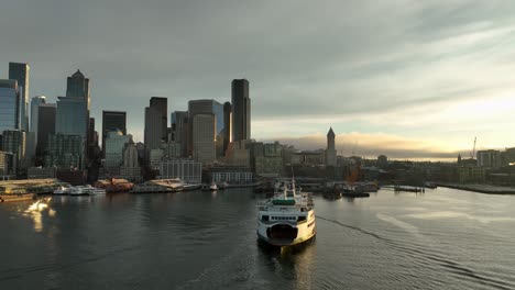 ferry traveling puget sound to seattle waterfront, aerial with cityscape view