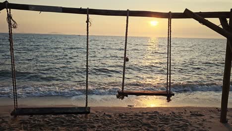 freedom of romantic vacation lifestyle with sunset seascape beach and swing silhouette