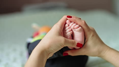 a mother holding her baby's feet