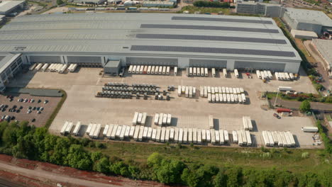 Circling-aerial-shot-over-a-truck-parking-in-a-warehouse-parking-lot