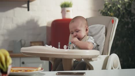 baby crying in high chair during mealtime