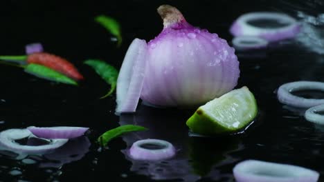 Onion-with-rings,-lime-and-chili-sprayed-with-water,-studio-view