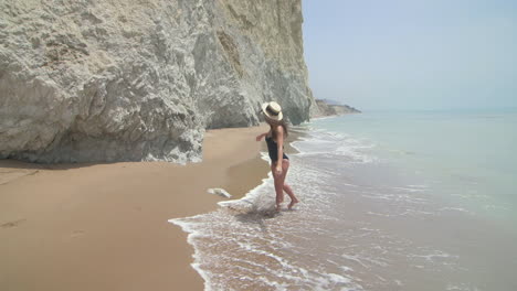 una mujer en bikini en una playa.