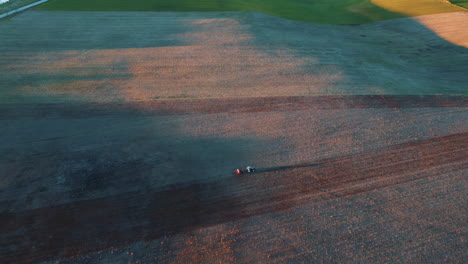 aerial view of tractor plowing a field at sunrise/sunset